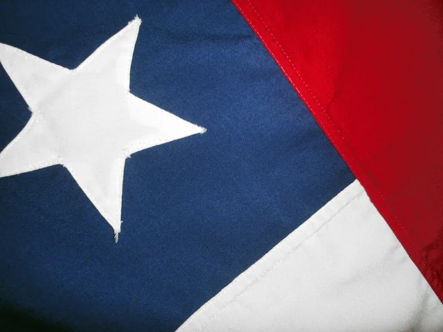 Close-up of a Chilean flag showing the stitched white star and the joins between its blue, white, and red fabric.