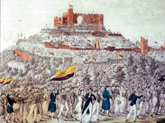 Erhard Joseph Brenzinger’s 1832 depiction of the procession to Hambach Castle. The colored reproduction shows flags with gold uppermost; it is historical artwork, not a guide to the current black-red-gold stripe order.