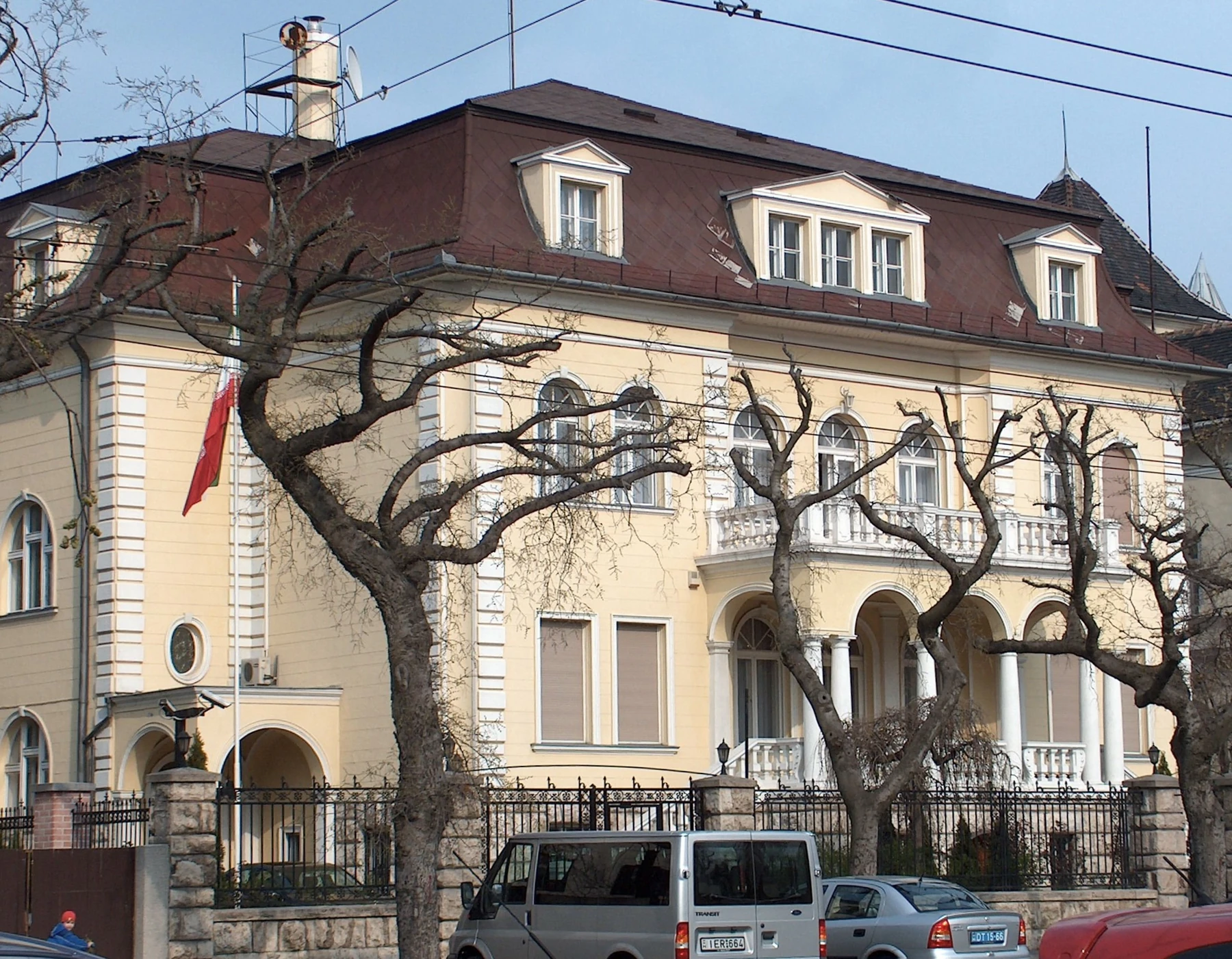 Iran’s flag hangs from a pole on the embassy building in Budapest in a photograph dated April 3, 2008. The folded cloth and surrounding branches partly obscure the design.